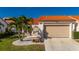 Single story home with tile roof, attached garage, and landscaped yard at 5089 San Rocco Ct, Punta Gorda, FL 33950