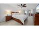 Spacious main bedroom with wooden bed frame and en-suite bathroom at 5089 San Rocco Ct, Punta Gorda, FL 33950