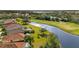 Aerial view of homes along golf course waterway at 5625 Whispering Oaks Dr, North Port, FL 34287