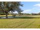 Landscaped backyard overlooking a peaceful golf course at 5625 Whispering Oaks Dr, North Port, FL 34287