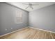 Light-filled bedroom with wood floors and ceiling fan at 5625 Whispering Oaks Dr, North Port, FL 34287