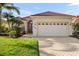 Attractive one-story home with a tiled roof and a two-car garage at 5625 Whispering Oaks Dr, North Port, FL 34287