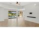 Bright living room with tile floors and sliding doors to the pool area at 5625 Whispering Oaks Dr, North Port, FL 34287