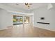 Bright living room with tile floors and sliding doors to the pool area at 5625 Whispering Oaks Dr, North Port, FL 34287