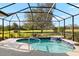 Relaxing screened pool and spa with a waterfall feature at 5625 Whispering Oaks Dr, North Port, FL 34287