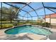 Enclosed kidney shaped pool with golf course view at 5625 Whispering Oaks Dr, North Port, FL 34287