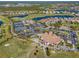 Aerial view of Heron Creek's clubhouse, tennis courts, and golf course at 5752 Whispering Oaks Dr., North Port, FL 34287