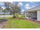 Landscaped backyard with screened patio and lake view at 5752 Whispering Oaks Dr., North Port, FL 34287