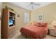 Bedroom with a double bed, built-in shelving, and a dresser at 5752 Whispering Oaks Dr., North Port, FL 34287