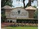 Entrance to Heron Creek Golf & Country Club, featuring a landscaped sign at 5752 Whispering Oaks Dr., North Port, FL 34287