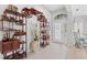 Bright entryway with tiled floors and a large, ornate wooden shelving unit at 5752 Whispering Oaks Dr., North Port, FL 34287