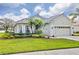 Single-story house with a two-car garage and well-manicured lawn at 5752 Whispering Oaks Dr., North Port, FL 34287