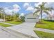 House exterior showcasing a two-car garage and a community entrance sign at 5752 Whispering Oaks Dr., North Port, FL 34287