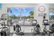 Modern fitness room with cardio equipment and pool view at 5752 Whispering Oaks Dr., North Port, FL 34287