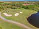 Aerial view of a golf course with a pond and green at 5752 Whispering Oaks Dr., North Port, FL 34287