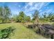 Large backyard with lush landscaping and natural vegetation at 6174 Alloway St, Englewood, FL 34224