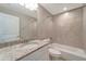 Bathroom with bathtub, granite countertop, and tiled walls at 6174 Alloway St, Englewood, FL 34224