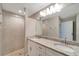 Bathroom with double vanity, granite countertop, and shower at 6174 Alloway St, Englewood, FL 34224