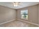 Bedroom with tile floors, window, and ceiling fan at 6174 Alloway St, Englewood, FL 34224