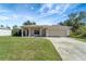 Newly constructed home with a two-car garage and a spacious front yard at 6174 Alloway St, Englewood, FL 34224