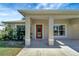 Covered porch with a red door and white columns at 6174 Alloway St, Englewood, FL 34224