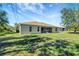 House exterior showcasing backyard and screened porch at 6174 Alloway St, Englewood, FL 34224