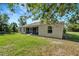 Tan house exterior with screened porch and grassy yard at 6174 Alloway St, Englewood, FL 34224