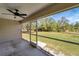 Spacious screened porch with ceiling fan and view of backyard at 6174 Alloway St, Englewood, FL 34224