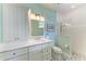 Clean bathroom with white cabinets and a walk-in shower at 668 W Olympia Ave, Punta Gorda, FL 33950