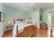 Light and airy bedroom with wood floors and a wooden bed frame at 668 W Olympia Ave, Punta Gorda, FL 33950