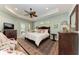 Main bedroom with hardwood floors, ceiling fan, and access to patio at 668 W Olympia Ave, Punta Gorda, FL 33950