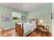 Bedroom with wooden bed frame and hardwood floors at 668 W Olympia Ave, Punta Gorda, FL 33950