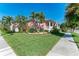 Charming two-story house with manicured lawn and tropical landscaping at 668 W Olympia Ave, Punta Gorda, FL 33950