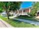 Two-story house with porch, landscaping, and a tree at 668 W Olympia Ave, Punta Gorda, FL 33950