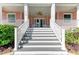 Inviting front porch with white railings and ceiling fan at 668 W Olympia Ave, Punta Gorda, FL 33950