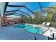 Irregular shaped pool and spa with screened enclosure at 668 W Olympia Ave, Punta Gorda, FL 33950