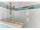 Walk-in shower with blue and green tile accents at 668 W Olympia Ave, Punta Gorda, FL 33950