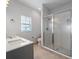 Modern bathroom with gray vanity, quartz countertop, and glass shower at 81 Michigan Ave, Englewood, FL 34223