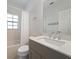 Clean bathroom with single vanity, shower/tub combo, and window at 81 Michigan Ave, Englewood, FL 34223