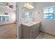 Bathroom with gray vanity, quartz countertop and view into bedroom at 81 Michigan Ave, Englewood, FL 34223