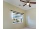 Bright bedroom with ceiling fan and colorful window treatment at 81 Michigan Ave, Englewood, FL 34223