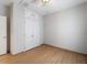 Simple bedroom with double door closet and wood-look tile floor at 81 Michigan Ave, Englewood, FL 34223