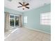 Bedroom with light-blue walls, tile floors and sliding glass doors at 81 Michigan Ave, Englewood, FL 34223