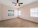 Spacious bedroom with light walls, wood-look tile floors, and large window at 81 Michigan Ave, Englewood, FL 34223