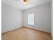 Simple bedroom with wood-look tile floor and window with blind at 81 Michigan Ave, Englewood, FL 34223