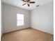 Simple bedroom with wood-look tile floor and window with blind at 81 Michigan Ave, Englewood, FL 34223