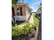 Tan house exterior with red shutters and a walkway leading to a waterfront view at 8773 Tuscany Isles Dr, Punta Gorda, FL 33950