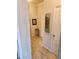 Clean and bright hallway with tile flooring and artwork at 8773 Tuscany Isles Dr, Punta Gorda, FL 33950