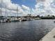 Calm marina with various boats docked under a partly cloudy sky at 8773 Tuscany Isles Dr, Punta Gorda, FL 33950