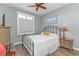 Bright bedroom with a metal bed frame and window coverings at 900 E Marion Ave # 1301, Punta Gorda, FL 33950